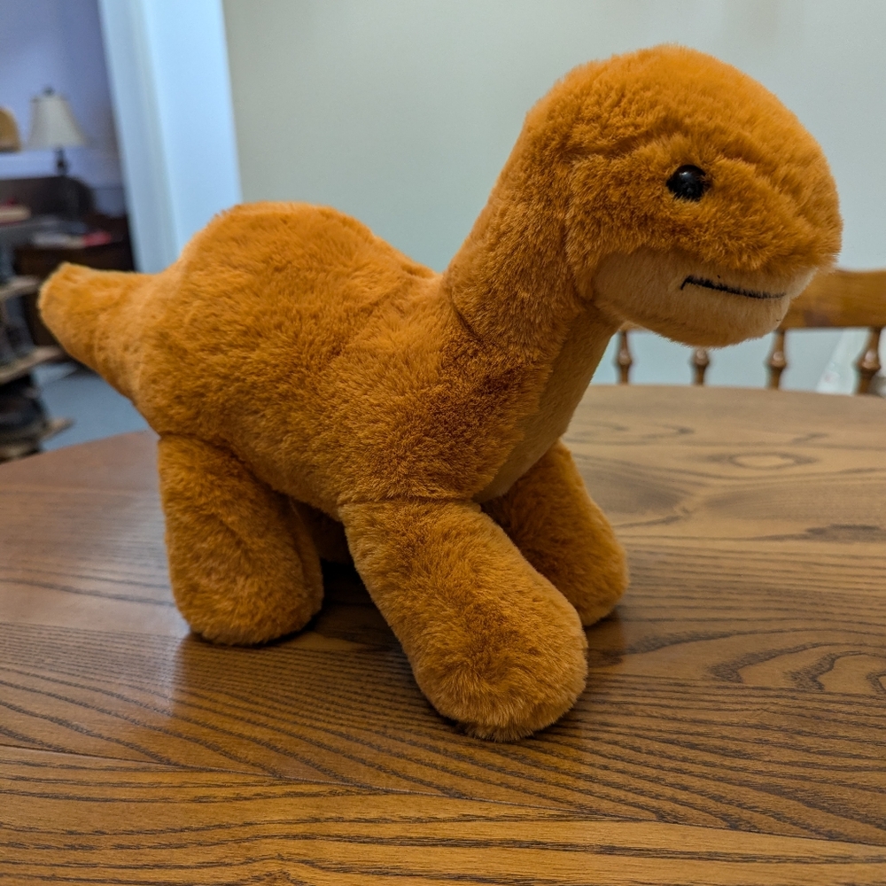 - Aurora plush Dinosaur. Orange colour. Super soft . EUC. 13 inches lo…